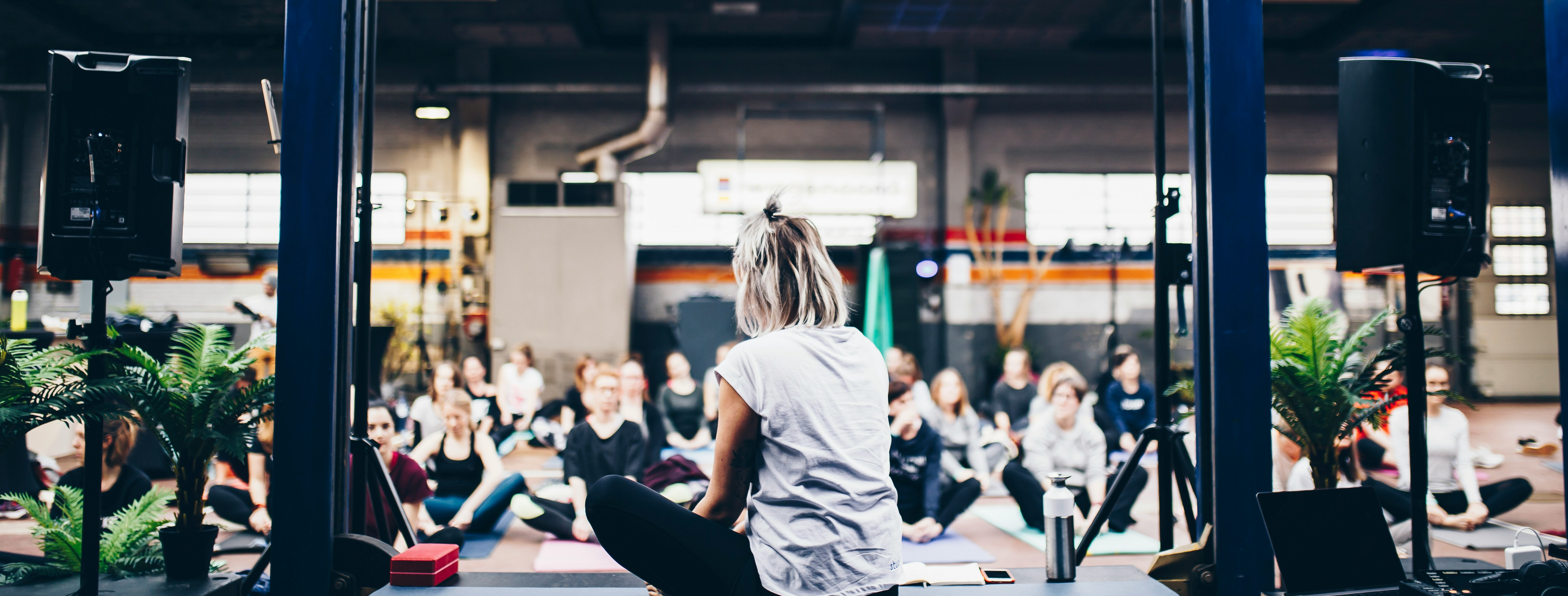 A yoga instructor sitting in front of a group